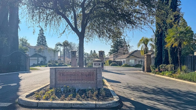 exterior space with a residential view, a gate, and fence