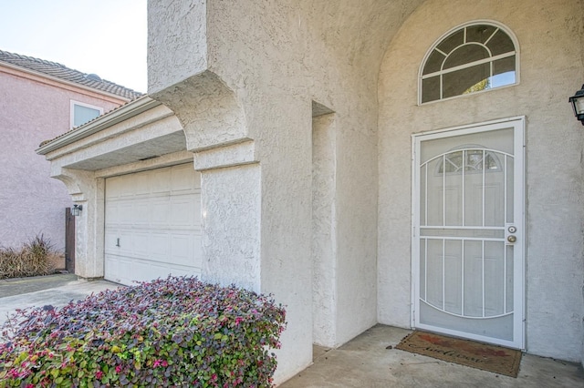 doorway to property with stucco siding