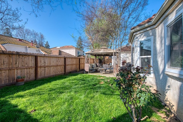 view of yard with a patio area, a fenced backyard, and a gazebo