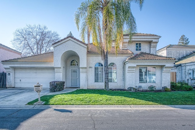 mediterranean / spanish-style home featuring an attached garage, driveway, a front lawn, and stucco siding