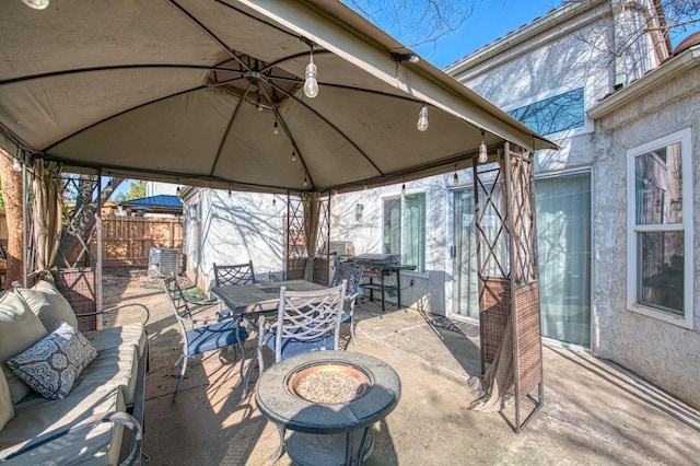 view of patio / terrace with an outdoor hangout area, a gazebo, outdoor dining area, and fence