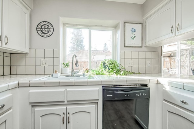 kitchen featuring white cabinets, dishwasher, tile countertops, and decorative backsplash