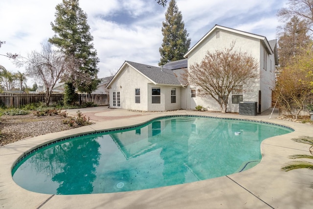 view of swimming pool with a patio, central AC, a fenced backyard, and a fenced in pool