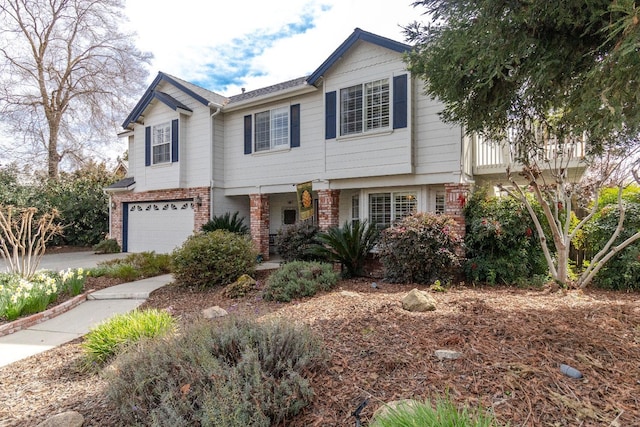 townhome / multi-family property featuring concrete driveway, brick siding, and an attached garage