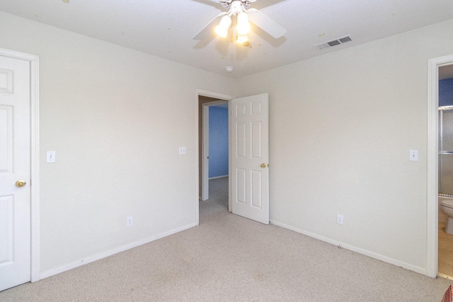 unfurnished bedroom with baseboards, ceiling fan, visible vents, and light colored carpet