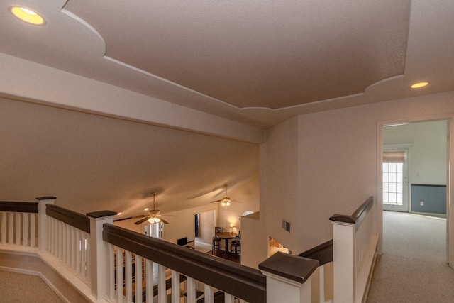 hall featuring visible vents, carpet floors, an upstairs landing, and recessed lighting