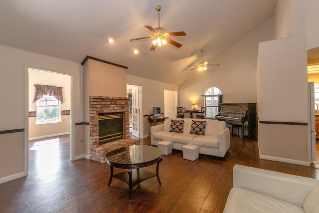 living room with high vaulted ceiling, a brick fireplace, baseboards, and dark wood-type flooring