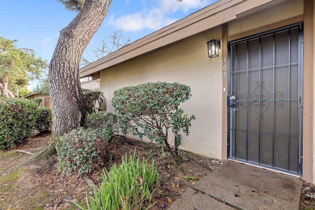 property entrance featuring stucco siding