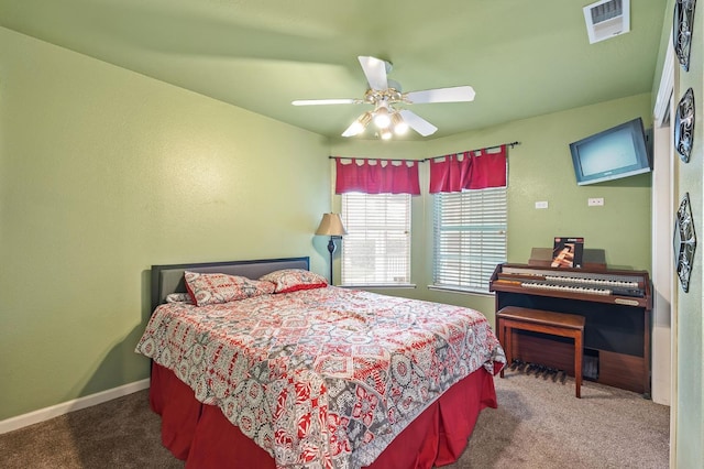 carpeted bedroom featuring ceiling fan, visible vents, and baseboards