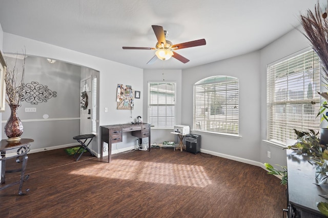 interior space with a ceiling fan, baseboards, and wood finished floors