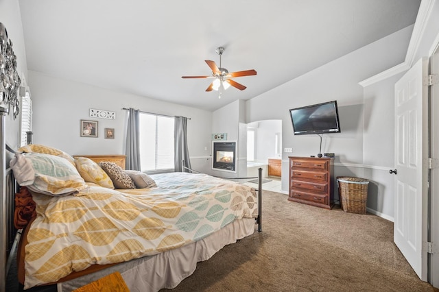 bedroom featuring carpet, ceiling fan, lofted ceiling, and a multi sided fireplace