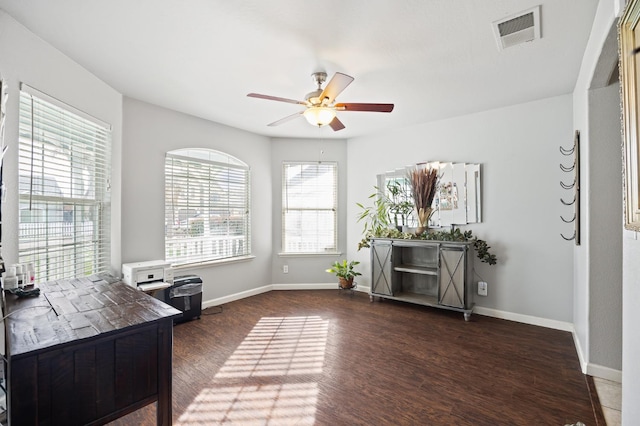 home office featuring a ceiling fan, visible vents, plenty of natural light, and wood finished floors