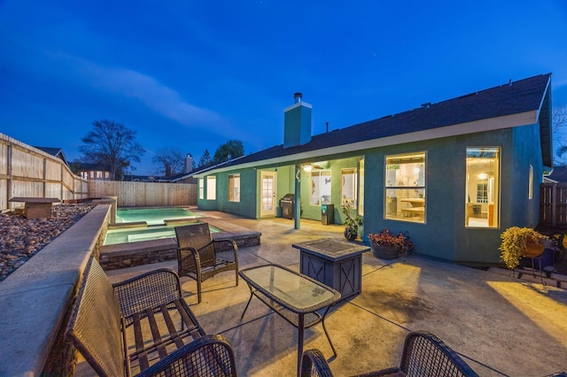 view of patio featuring a fenced backyard, a fenced in pool, and area for grilling