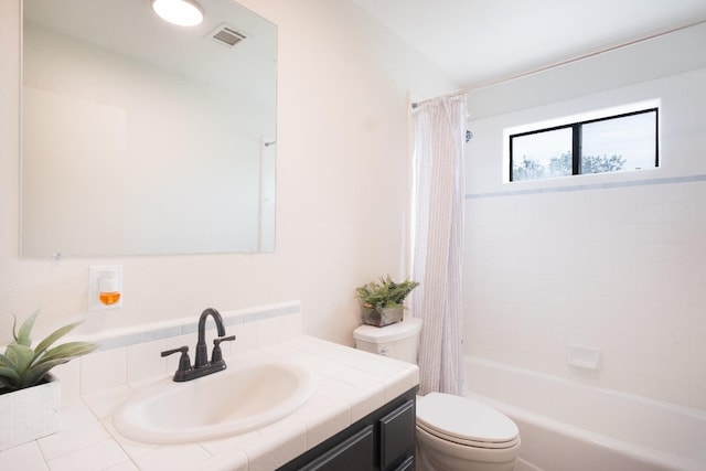 bathroom with visible vents, shower / tub combo with curtain, vanity, and toilet