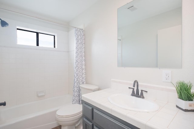 bathroom with shower / bath combo, visible vents, vanity, and toilet