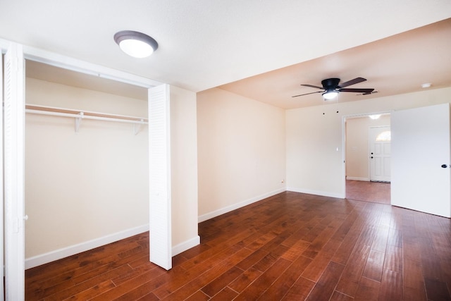 unfurnished bedroom featuring a ceiling fan, a closet, baseboards, and dark wood-type flooring