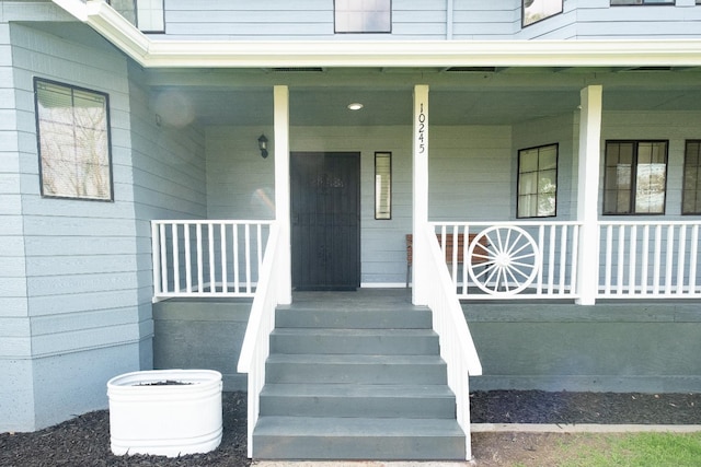 doorway to property featuring covered porch