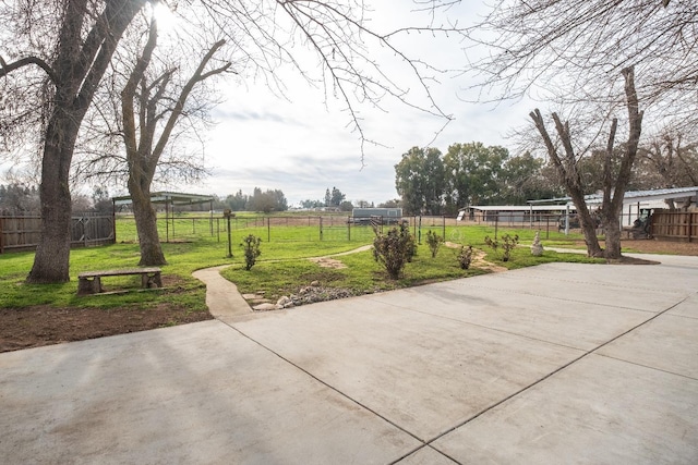 view of patio featuring a rural view and fence