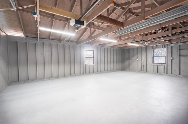 basement with a garage and a wealth of natural light