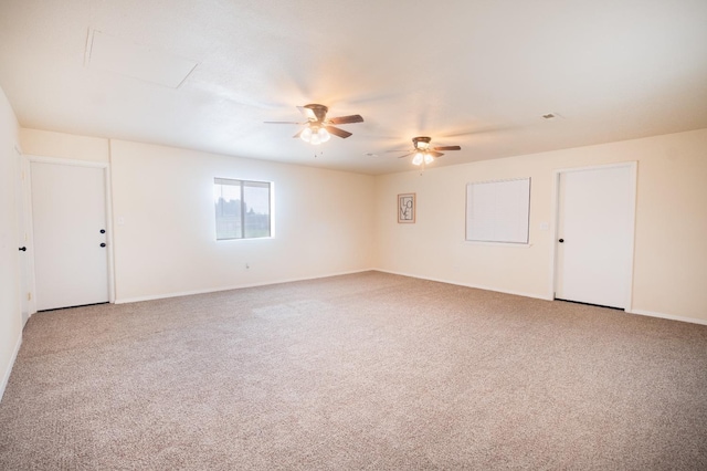 spare room with ceiling fan and carpet