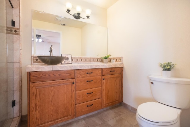 bathroom featuring visible vents, toilet, vanity, tile patterned flooring, and baseboards