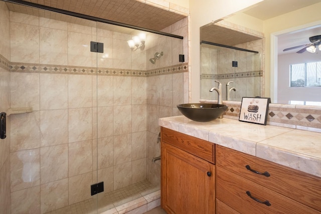 full bath featuring a stall shower, ceiling fan, and vanity