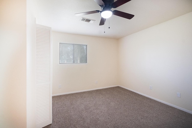 empty room featuring a ceiling fan, carpet flooring, visible vents, and baseboards