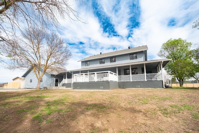 back of house featuring covered porch and crawl space