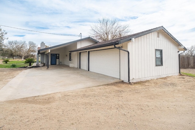 view of side of property with a garage and driveway