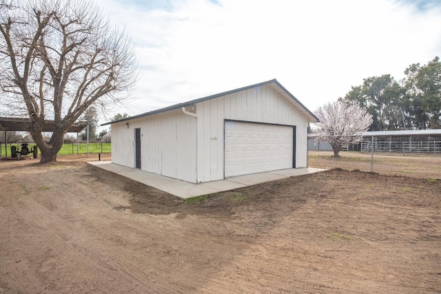 detached garage featuring fence