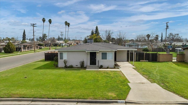 single story home with stucco siding, a shingled roof, a front yard, fence, and a residential view