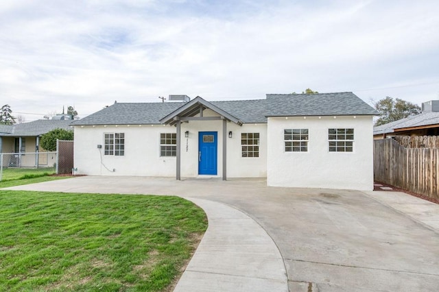 single story home with stucco siding, fence, and a front yard