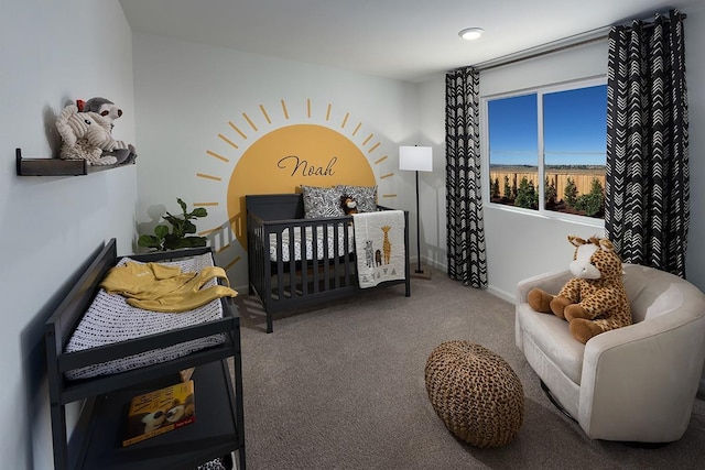 bedroom with carpet floors, a crib, and baseboards