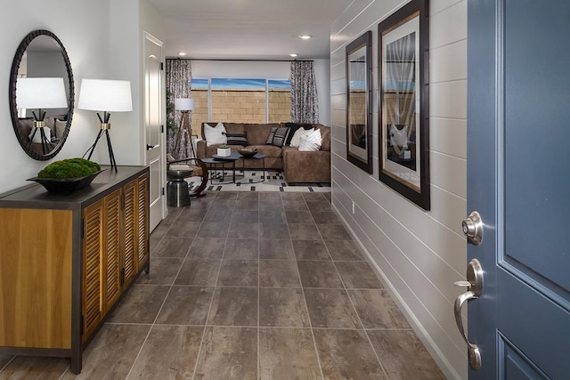 hallway featuring dark tile patterned flooring and recessed lighting