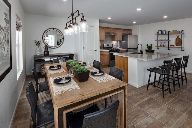 dining room featuring dark tile patterned floors, baseboards, and recessed lighting