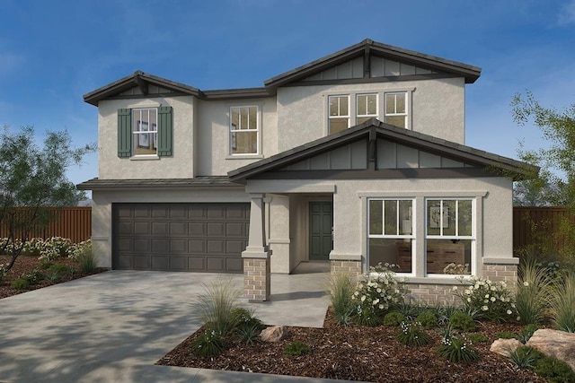 view of front of property with an attached garage, fence, concrete driveway, stone siding, and board and batten siding