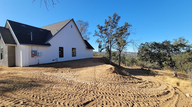 view of home's exterior featuring a shingled roof