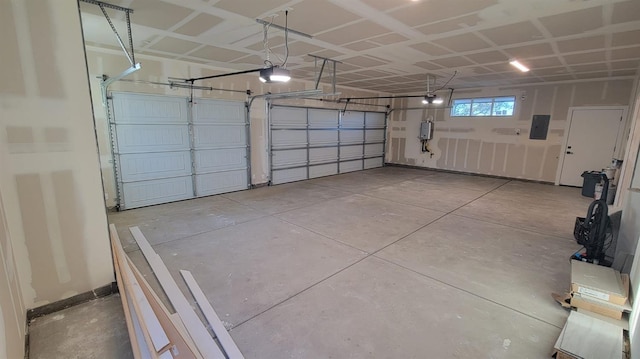 garage featuring electric panel and a garage door opener