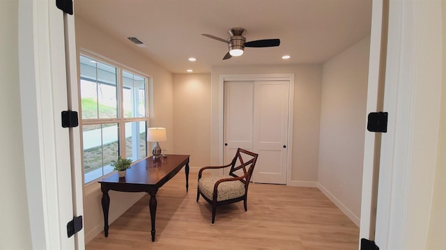 sitting room with light wood-type flooring, visible vents, a ceiling fan, recessed lighting, and baseboards