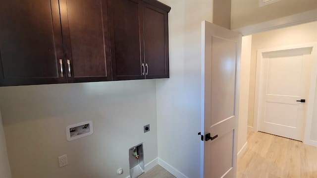 washroom with gas dryer hookup, light wood-type flooring, washer hookup, cabinet space, and hookup for an electric dryer