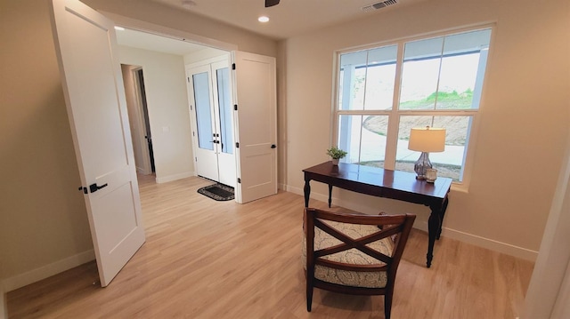 interior space featuring baseboards and light wood finished floors