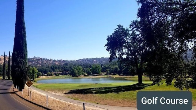 view of property's community featuring a yard and a water view