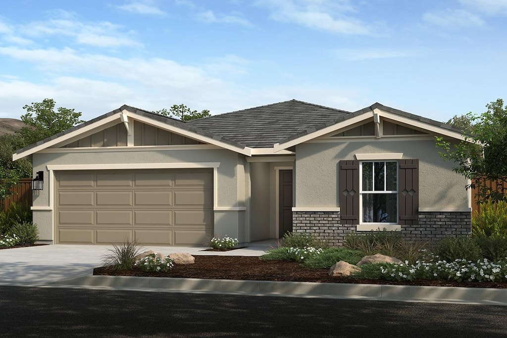 view of front of home featuring a garage, concrete driveway, a shingled roof, and stucco siding