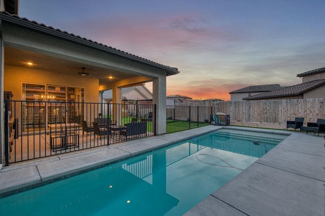 view of swimming pool featuring a fenced in pool, a patio area, a fenced backyard, and ceiling fan