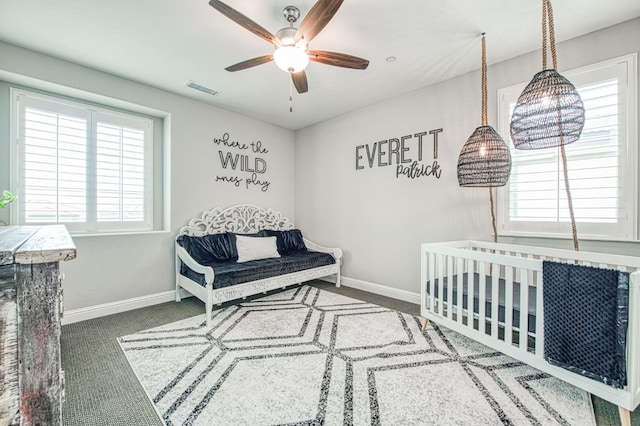 carpeted bedroom with a ceiling fan, visible vents, and baseboards