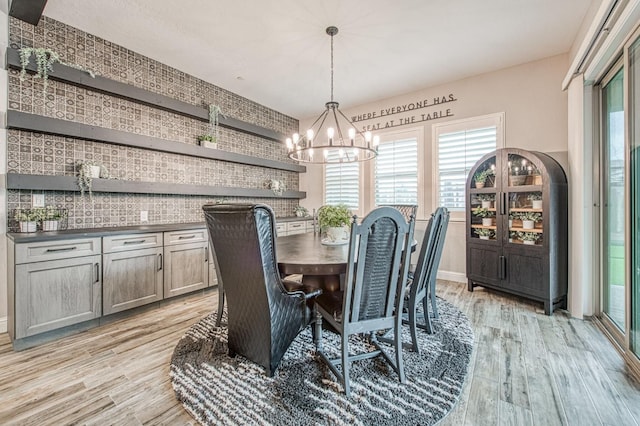 dining space featuring a chandelier and light wood finished floors