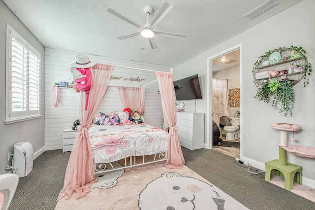 carpeted bedroom featuring visible vents, a ceiling fan, a textured ceiling, ensuite bath, and baseboards