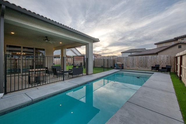 view of pool with a ceiling fan, a fenced in pool, a fenced backyard, and a patio