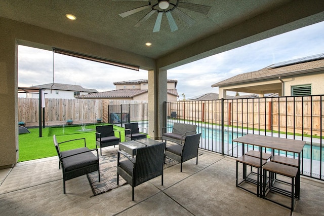 view of patio featuring a fenced backyard, ceiling fan, and a fenced in pool