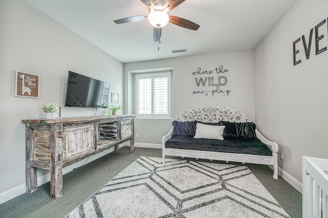 living area featuring carpet, baseboards, visible vents, and ceiling fan